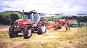 Contractor rowing silage prior to big-baling